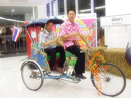 Mayor Itthiphol Kunplome tries out a rickshaw with Royal Garden Plaza and Royal Garden Entertainment vice president, Somporn Naksuetrong in the cab.